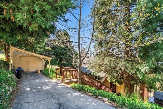 view of patio / terrace with a deck and a storage unit