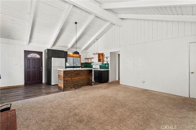 kitchen with decorative light fixtures, backsplash, white refrigerator, dark colored carpet, and beam ceiling