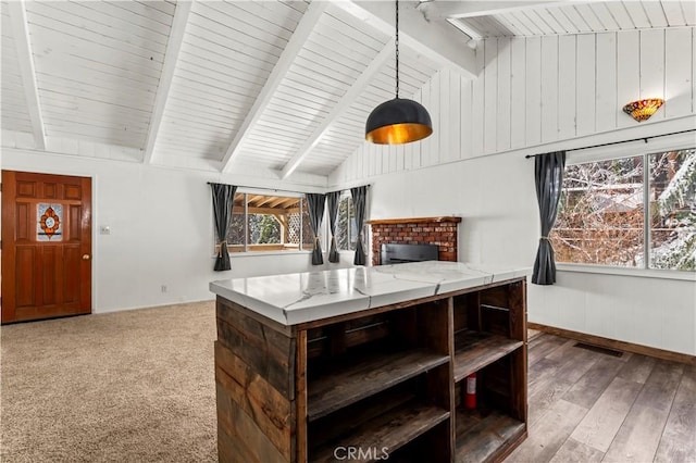 interior space with hardwood / wood-style flooring and lofted ceiling with beams