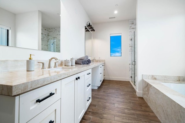 bathroom featuring independent shower and bath, vanity, and hardwood / wood-style floors