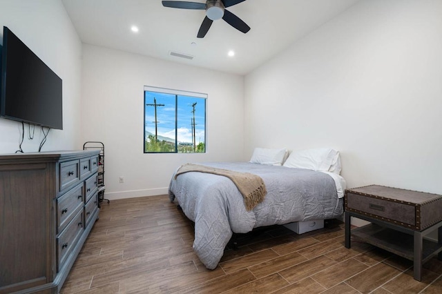 bedroom with dark wood-type flooring and ceiling fan