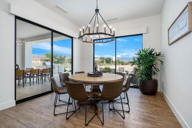 dining space with a chandelier and wood-type flooring