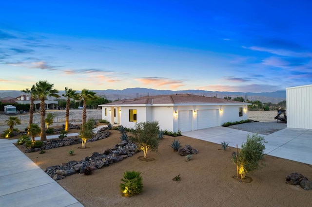 view of front of property featuring a garage and a mountain view