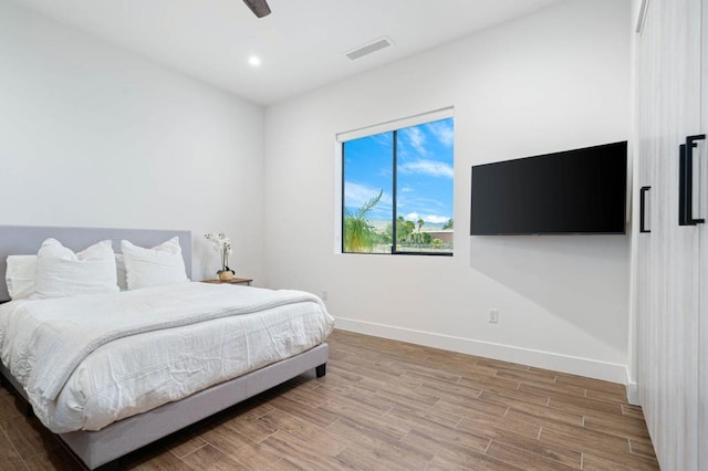 bedroom with wood-type flooring and ceiling fan