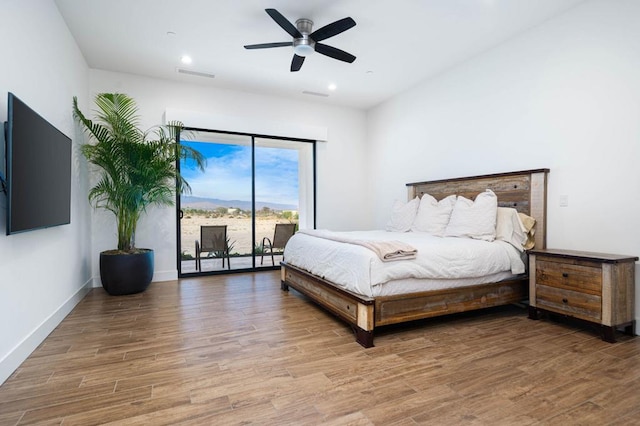 bedroom featuring ceiling fan, access to outside, and wood-type flooring