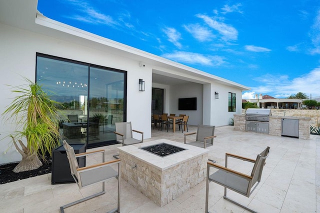 view of patio / terrace with an outdoor fire pit and area for grilling