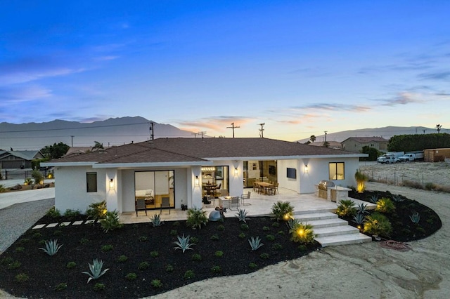 view of front of property featuring a patio and a mountain view