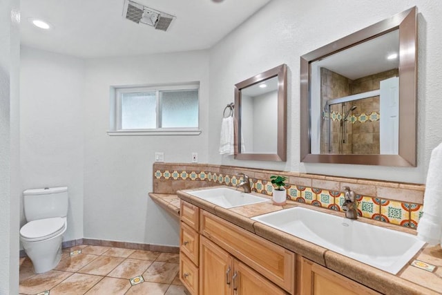 bathroom with tile patterned flooring, dual vanity, tasteful backsplash, and toilet