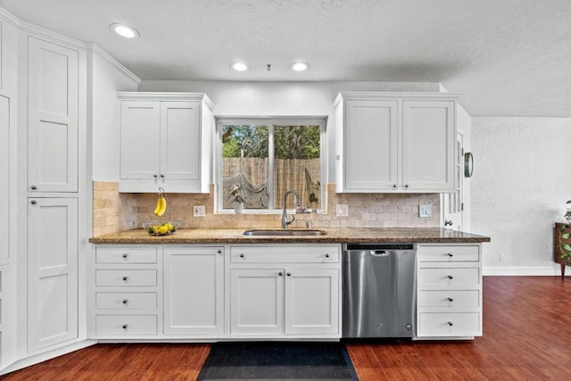 kitchen featuring sink, stainless steel dishwasher, white cabinetry, stone countertops, and dark wood-type flooring