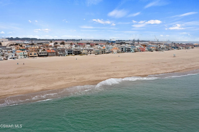 birds eye view of property with a view of the beach and a water view