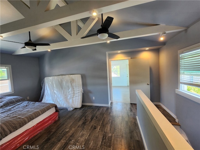 bedroom with dark hardwood / wood-style flooring, lofted ceiling with beams, and ceiling fan