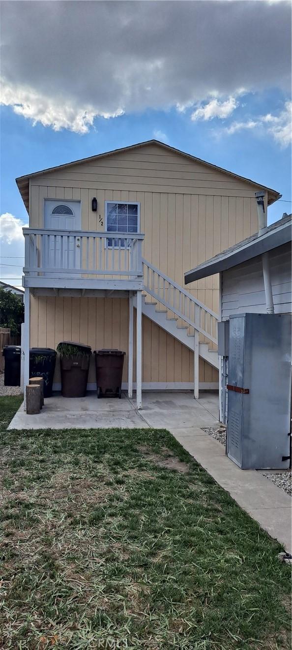 back of house featuring a patio area and a yard