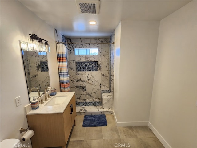 bathroom featuring curtained shower, tile flooring, and vanity