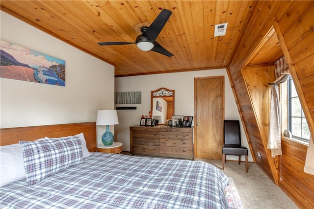 carpeted bedroom with wood ceiling, ceiling fan, vaulted ceiling, ornamental molding, and wood walls