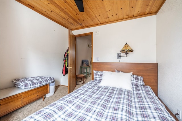 carpeted bedroom featuring ceiling fan, wooden ceiling, vaulted ceiling, and ornamental molding