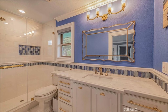 bathroom with toilet, ornamental molding, an enclosed shower, and vanity