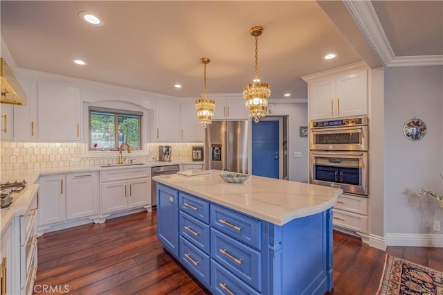 kitchen with pendant lighting, sink, appliances with stainless steel finishes, white cabinets, and blue cabinets