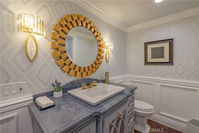 bathroom with toilet, crown molding, hardwood / wood-style floors, and vanity