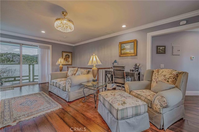 living room with a chandelier, wood-type flooring, and ornamental molding