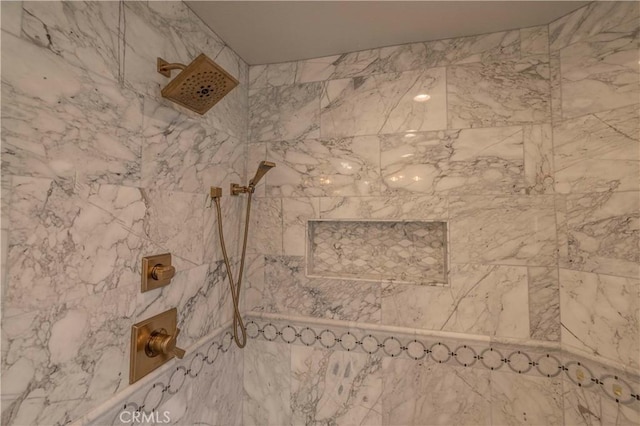 interior details with a tile shower