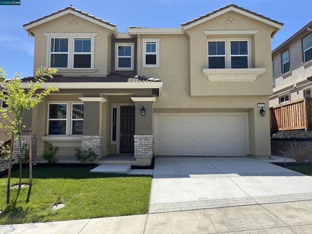 view of front of property featuring a garage and a front yard