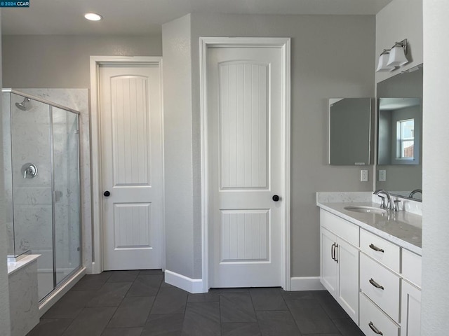 bathroom with tile patterned flooring, vanity, and an enclosed shower