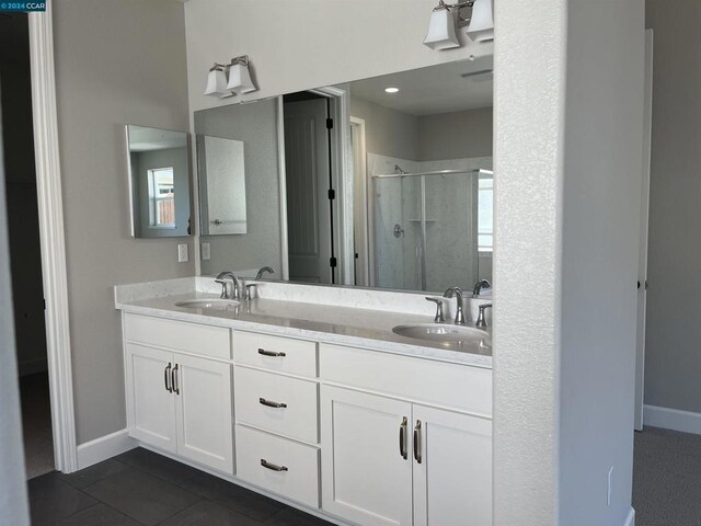 bathroom featuring vanity, tile patterned floors, and walk in shower