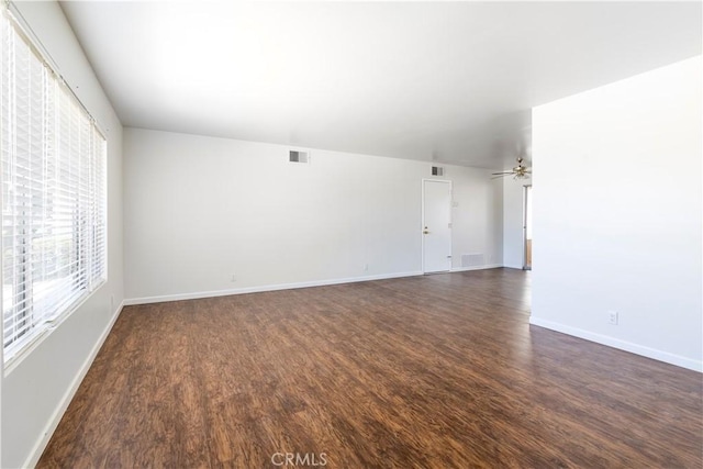 spare room with ceiling fan and dark wood-type flooring