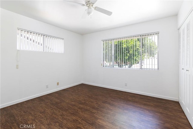 unfurnished room featuring ceiling fan and dark hardwood / wood-style floors