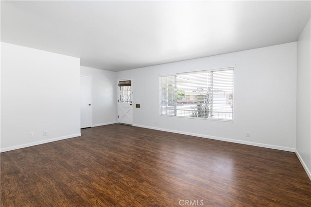 spare room featuring dark hardwood / wood-style floors