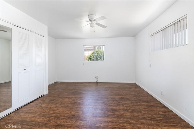 unfurnished bedroom with ceiling fan, dark wood-type flooring, and a closet