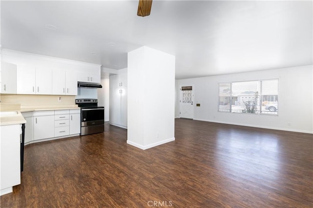 kitchen featuring stainless steel electric range oven, ceiling fan, dark wood-type flooring, white cabinets, and sink