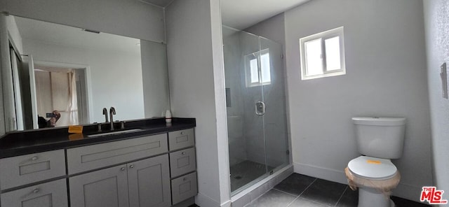 bathroom with a shower with shower door, tile flooring, vanity, and toilet