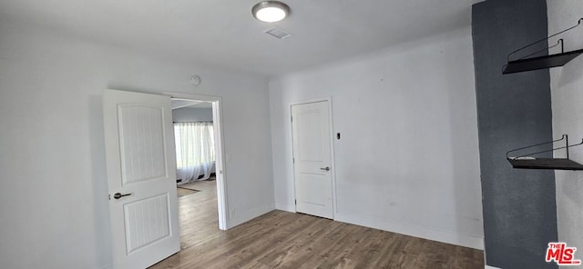 unfurnished bedroom featuring wood-type flooring