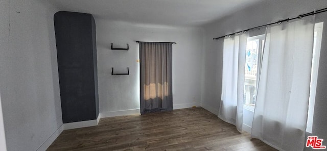 unfurnished room with hardwood / wood-style flooring