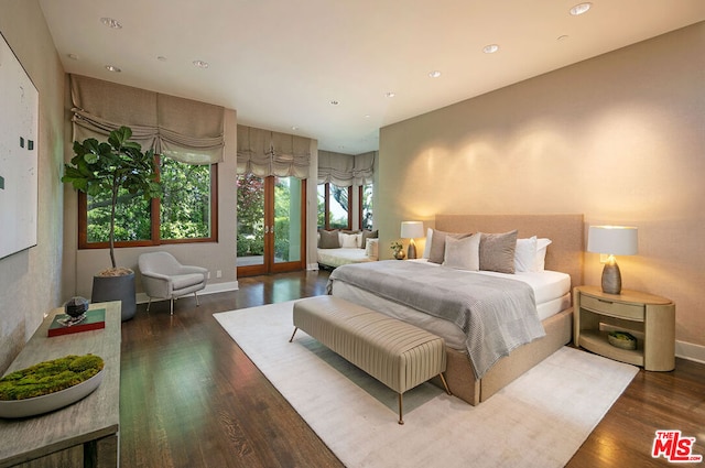 bedroom with dark hardwood / wood-style floors and french doors