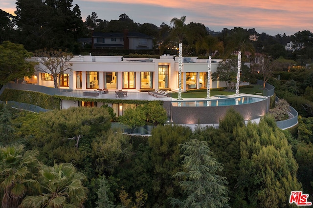 view of back house at dusk