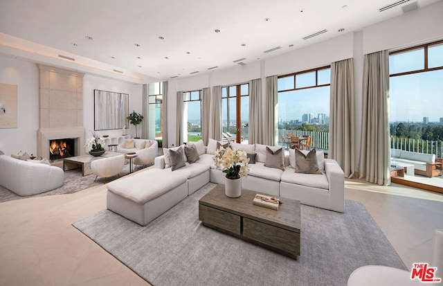 living room featuring a large fireplace and a wealth of natural light