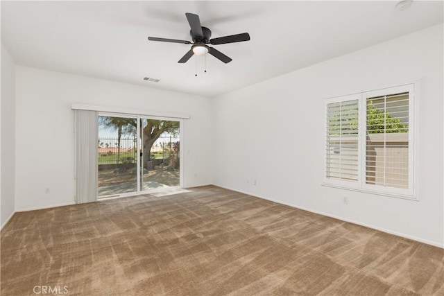 empty room with ceiling fan and carpet flooring