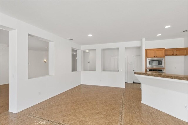 kitchen featuring light tile patterned floors and appliances with stainless steel finishes