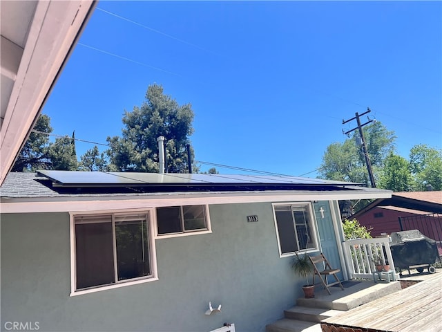 view of property exterior with solar panels