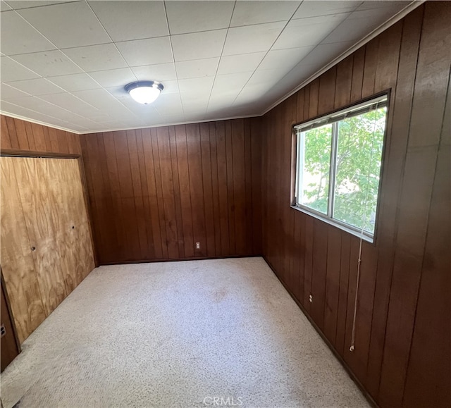 empty room with wooden walls and carpet