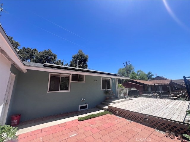 rear view of house featuring a patio area and a deck