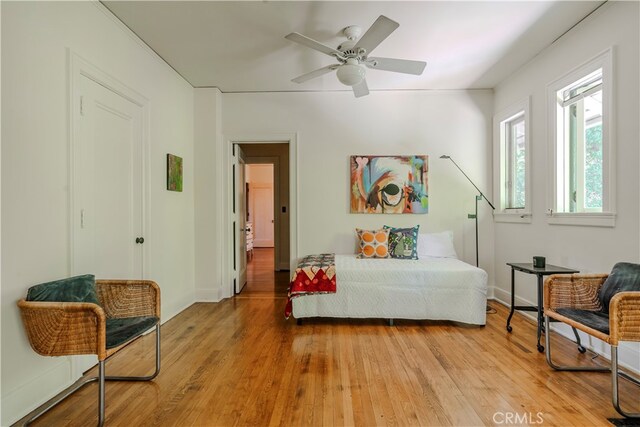 sitting room featuring light hardwood / wood-style floors and ceiling fan