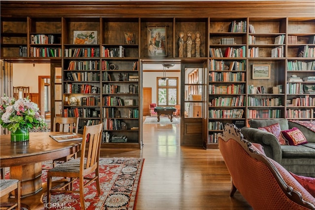 living area with wood-type flooring and billiards