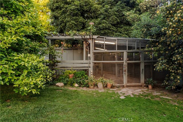 view of outdoor structure featuring a lawn