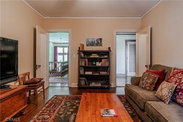 living room featuring crown molding and dark wood-type flooring