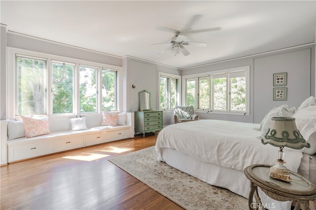 bedroom with ceiling fan and wood-type flooring