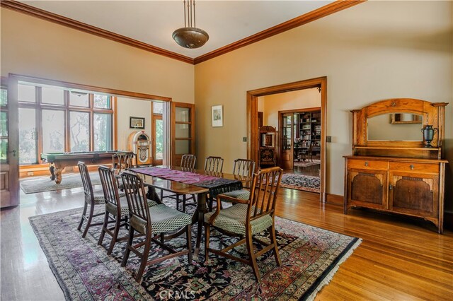 dining room featuring hardwood / wood-style floors, ornamental molding, and billiards