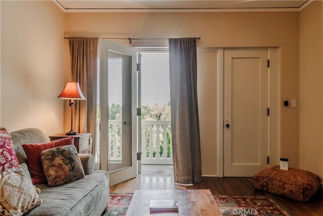 interior space with hardwood / wood-style floors and crown molding